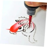 a person drawing a fish with a red marker