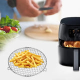 a person is preparing food in a small air fryer