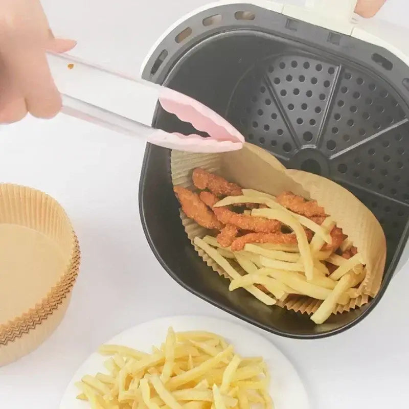 a person is putting fries into a basket