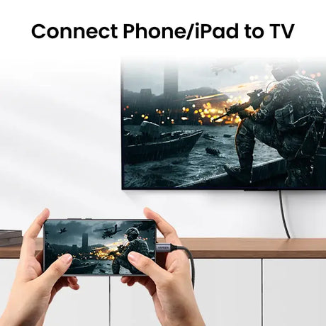 A person holding a game controller in front of a tv