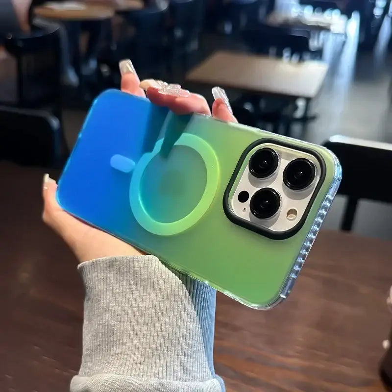 A person holding a green and blue iphone case