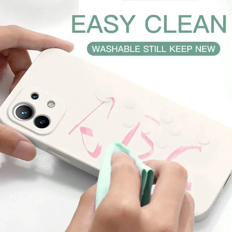 a person using a green marker to paint on a phone