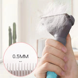 a person holding a hair brush with a white feather on it