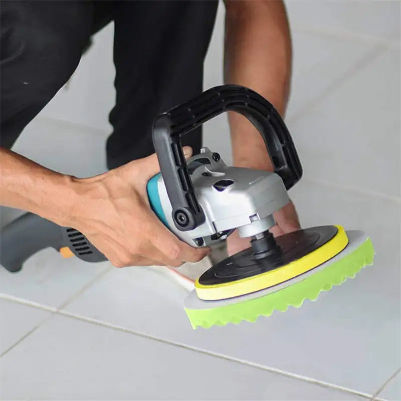 a man using a sander to clean a tile floor
