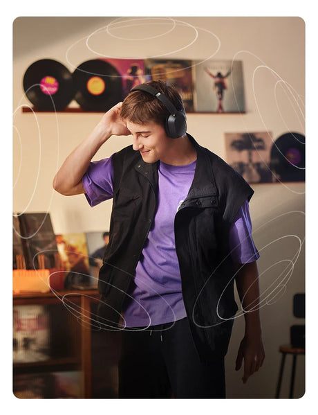 Person wearing headphones and a purple shirt, smiling and appearing to dance or move to music.