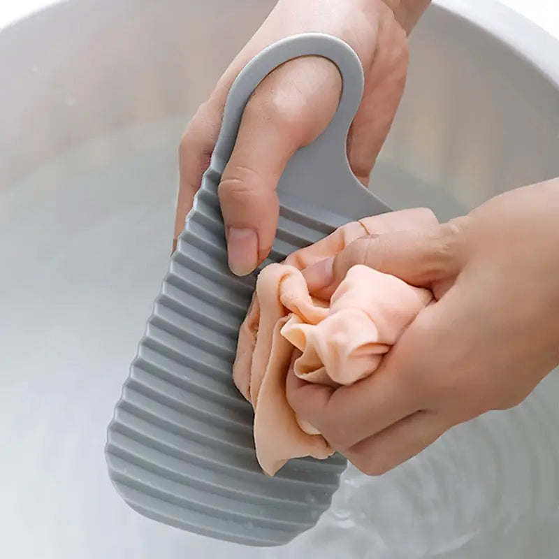 a person is using a plastic brush to clean the sink