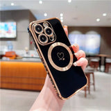 a person holding a black and gold iphone case