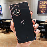 a person holding up a black and gold phone