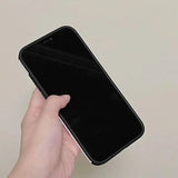 a hand holding a black iphone