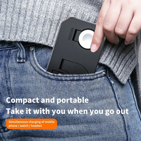 a hand holding a black phone in the pocket