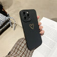 a person holding a black phone case with a heart on it