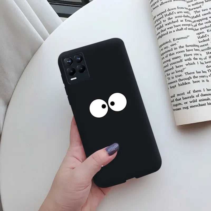 a black phone case with a white eye on it