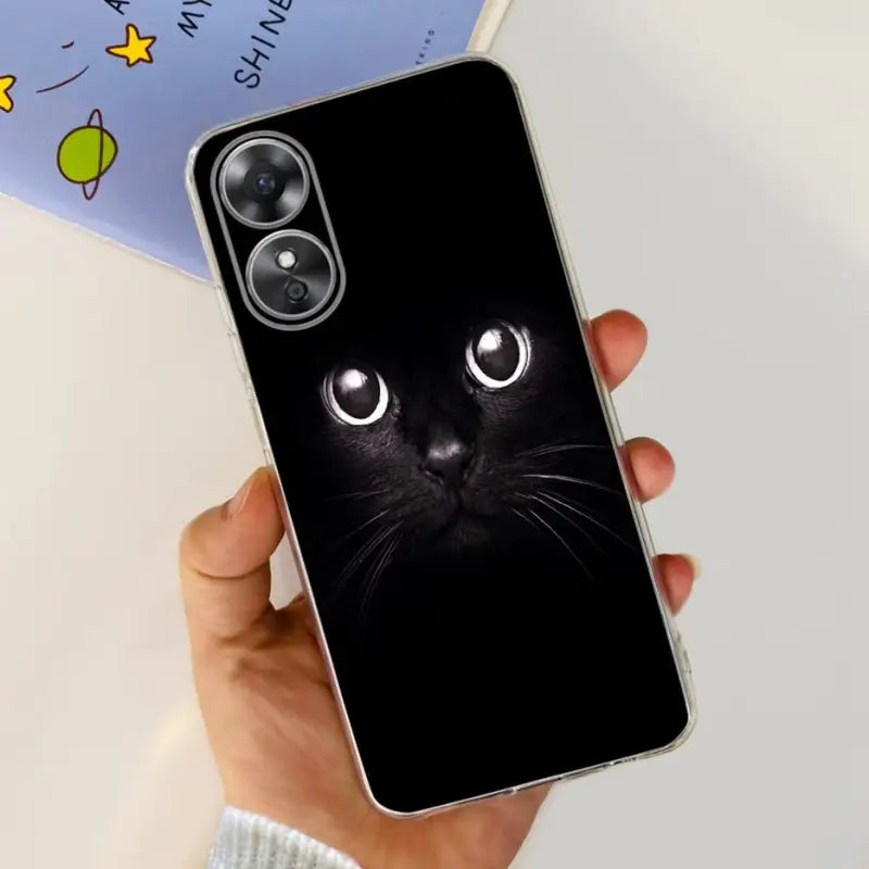 a person holding a black cat phone case