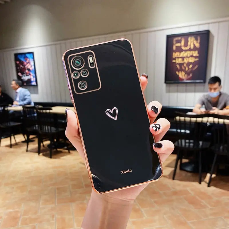 a woman holding up her phone in a restaurant