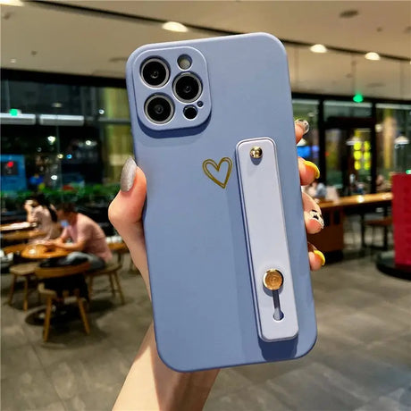 a person holding a phone case with a heart on it