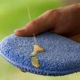 a person is holding a blue towel with a needle