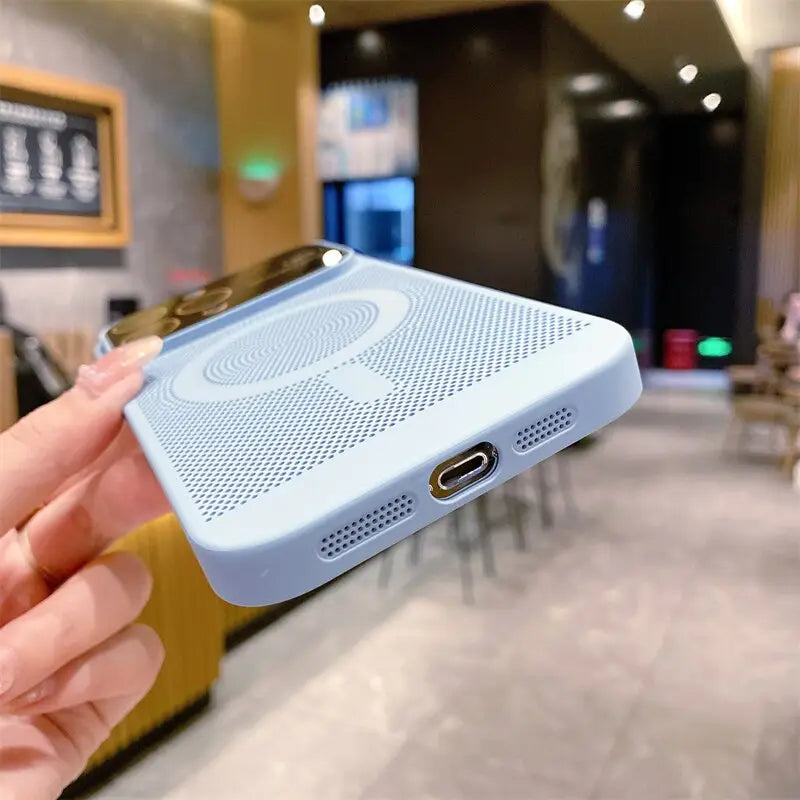 a person holding a bluetooth speaker in their hand