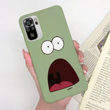 a person holding a book with a green phone case