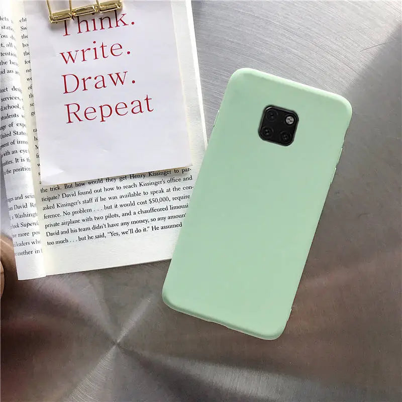 a person holding a book and a green phone case