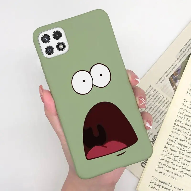 a person holding a book and a phone case