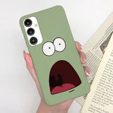 a person holding a book with a green phone case