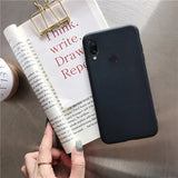 a hand holding a book and a phone case