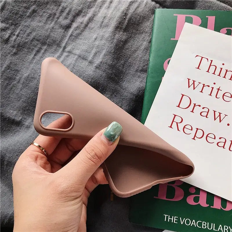 a person holding a book with a pink cover