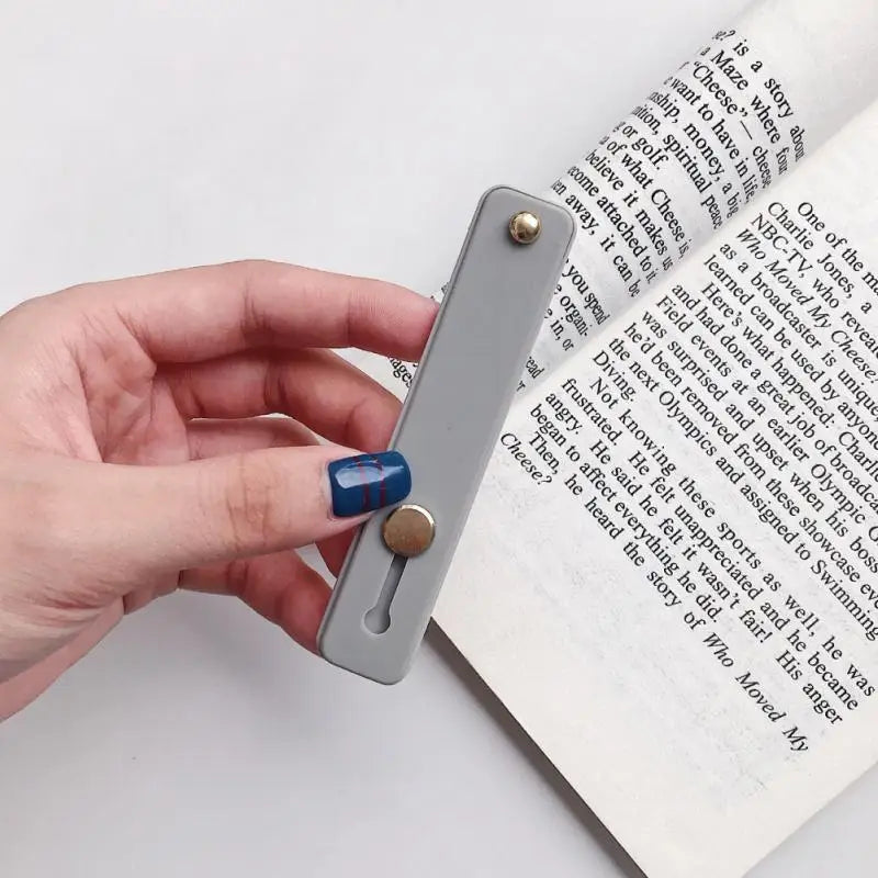 a hand holding a book with a pen