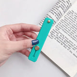 a person is opening a book with a blue pen