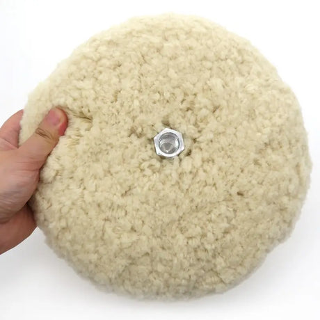 a person is holding a button on a white surface