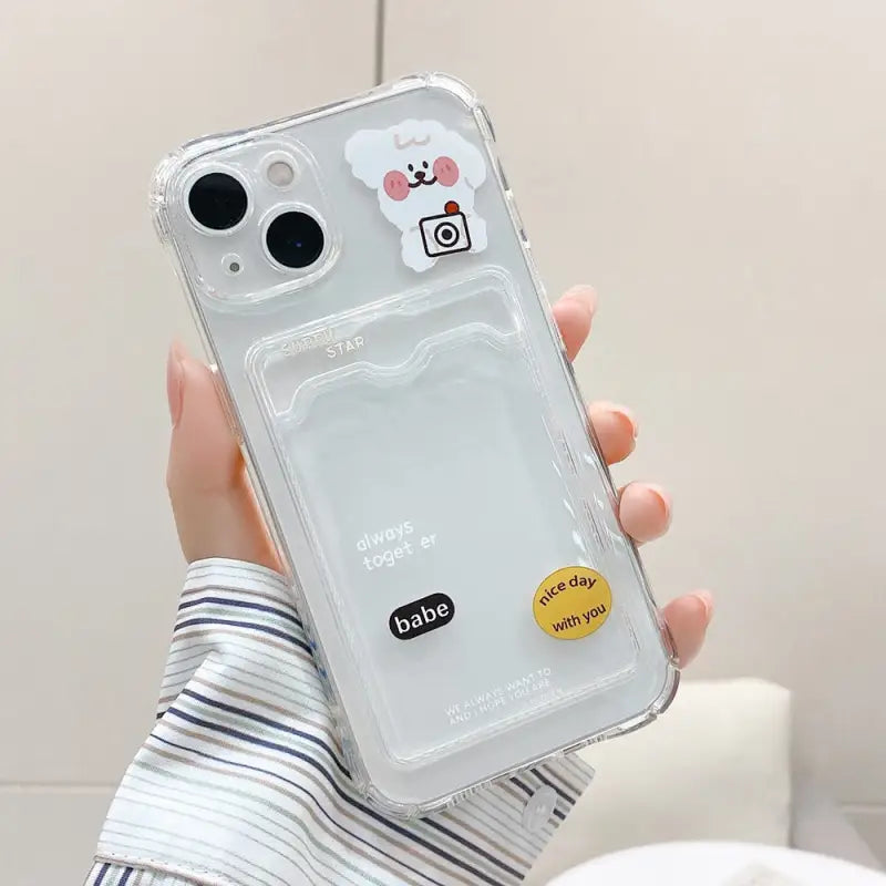 a person holding a clear case with a phone in the background