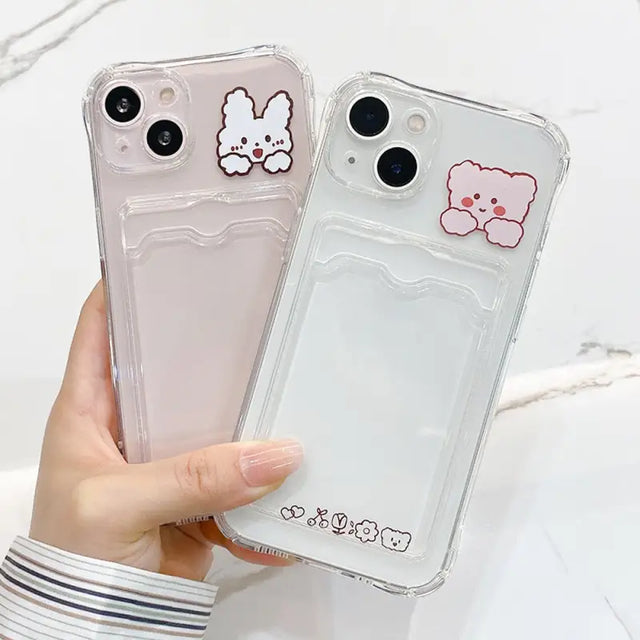a person holding a clear case with a white bear