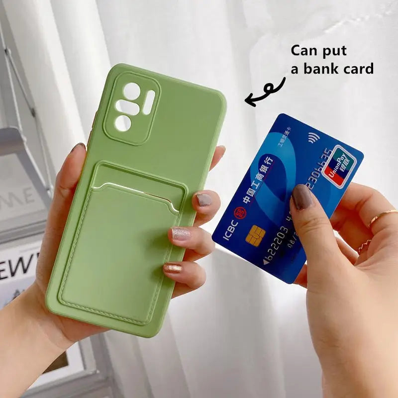 a person holding a credit card and a green phone case