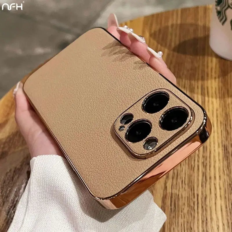 someone holding a gold case with three black buttons on it
