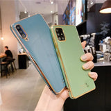 a person holding a green and blue iphone case