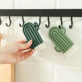 a person holding a green cactus plant on a black hook