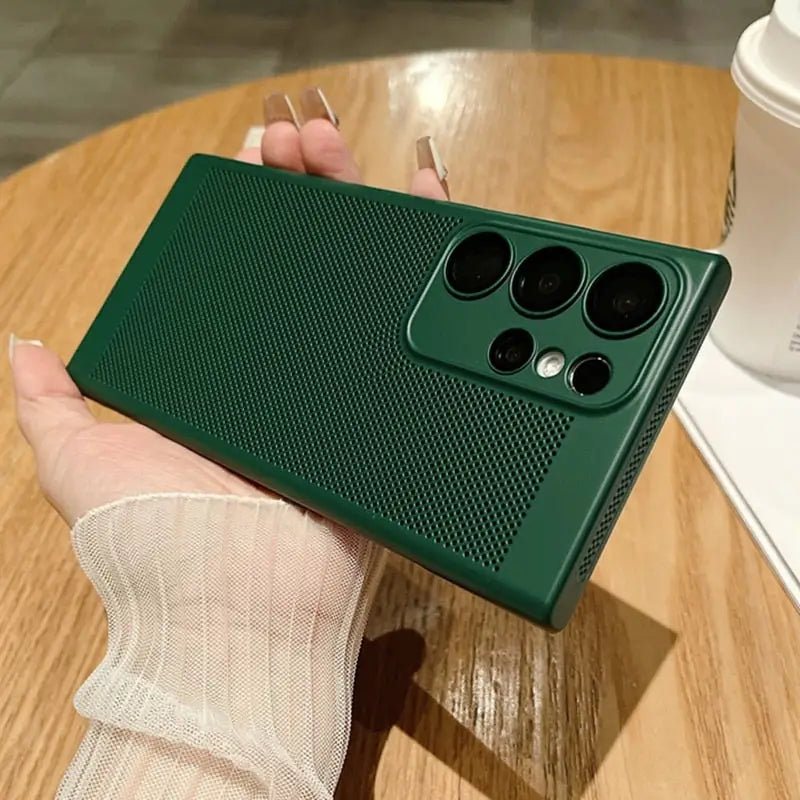 a person holding a green phone case