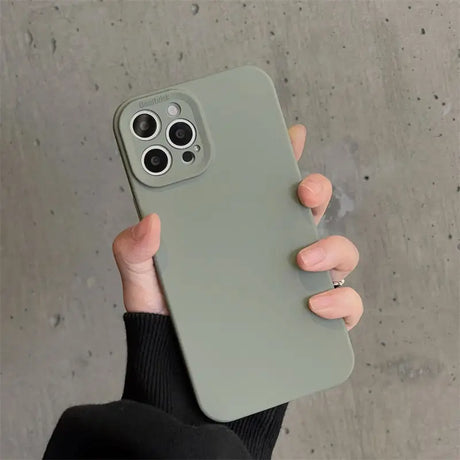 a person holding a green iphone case