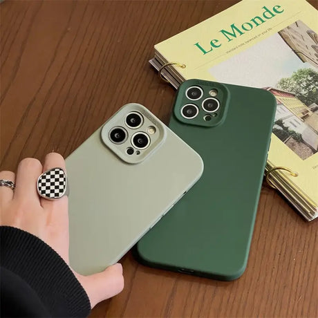 a person holding a green iphone case