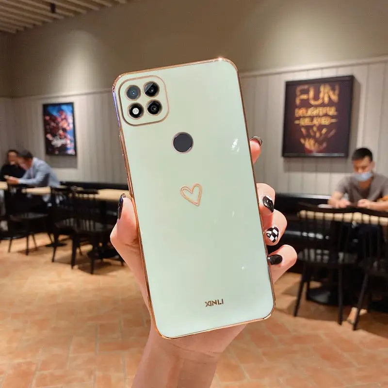 a person holding up a phone with a heart on it
