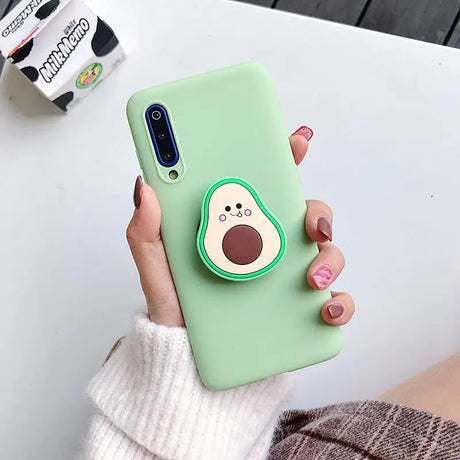 a woman holding a green phone case with a dog on it