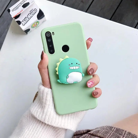 a person holding a green phone case