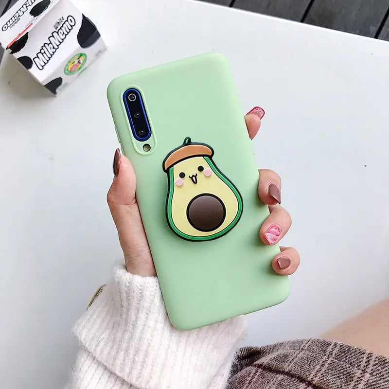 a woman holding a green phone case with a bird on it