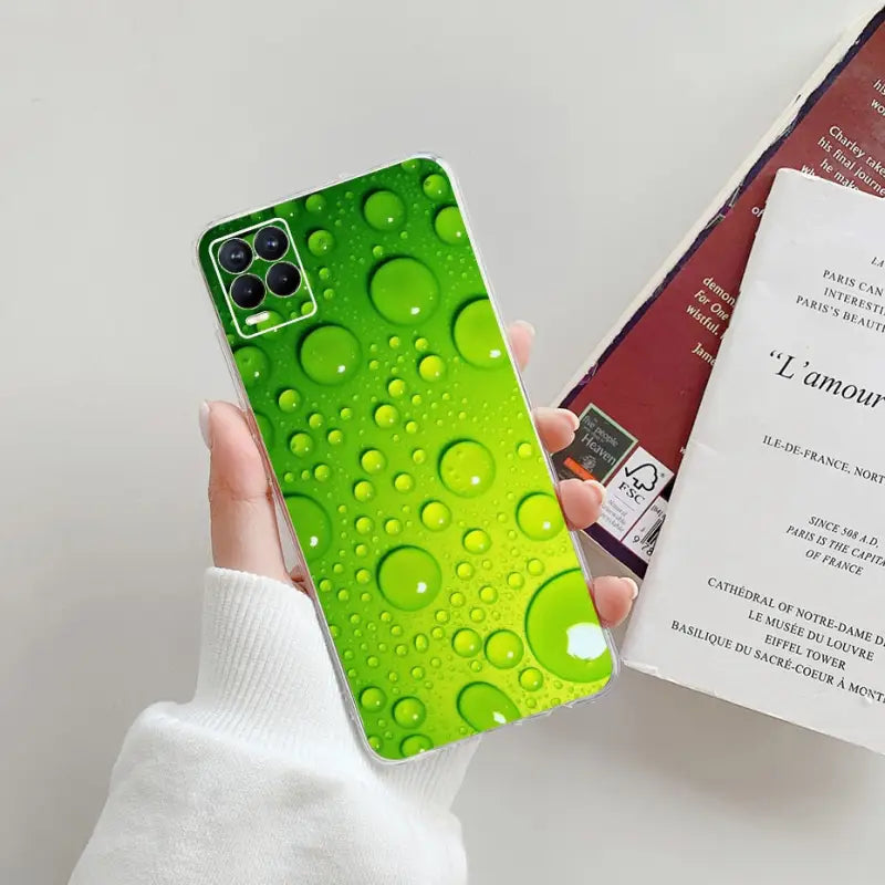 a person holding a phone case with water droplets on it