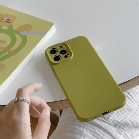 a person holding a green phone case