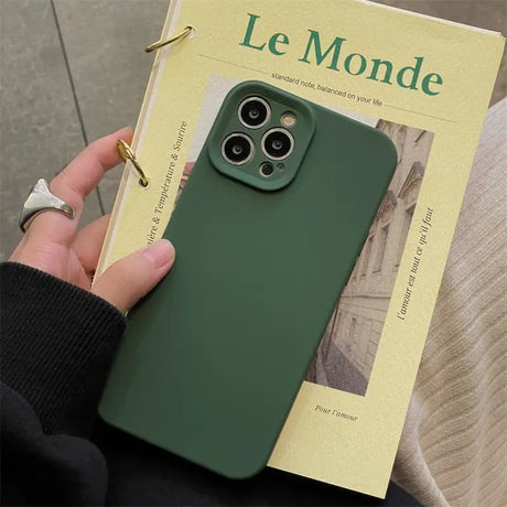 a person holding a green phone case