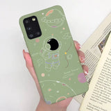 a woman holding a green phone case with a cartoon character on it