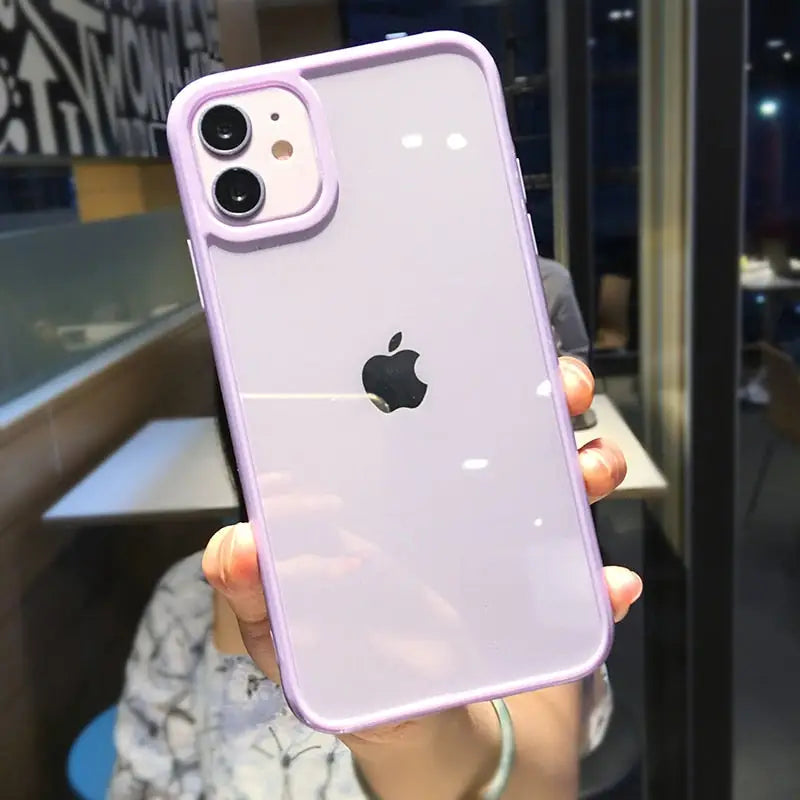 a woman holding up a purple iphone case