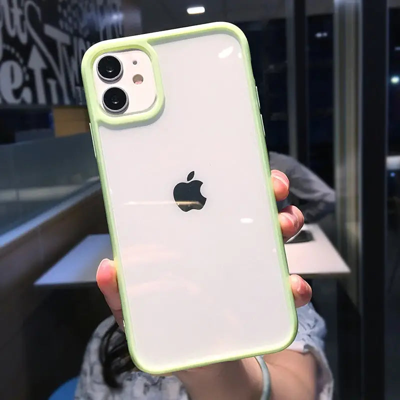 a woman holding up a green iphone case