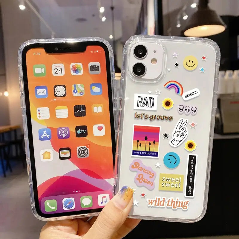 a person holding a phone case with stickers on it